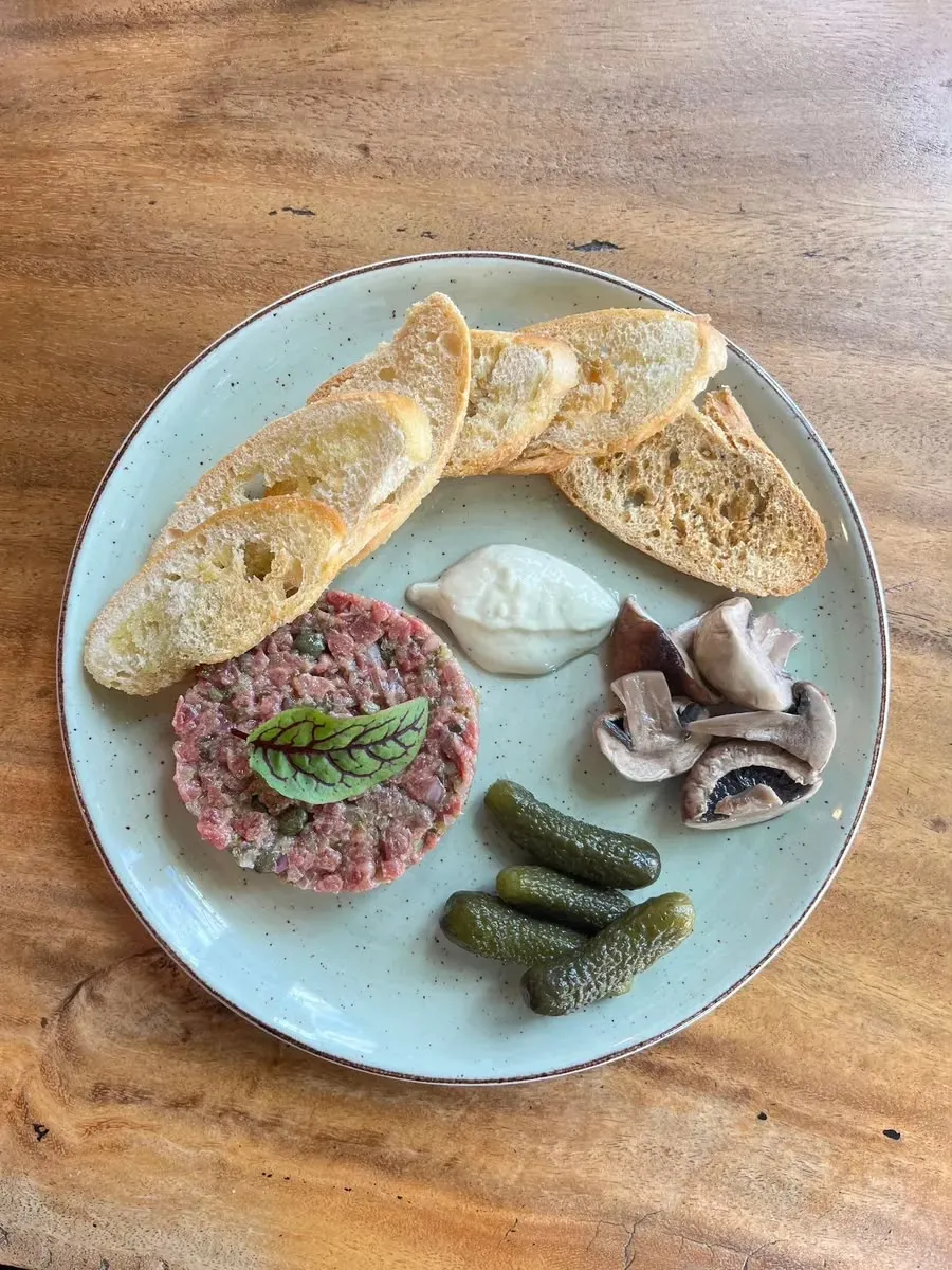 Hand-cut steak tartare served with toasted sourdough, creamy sauce, mushrooms and cornichons at Nola Eatery & Bar in Leslieville, Toronto