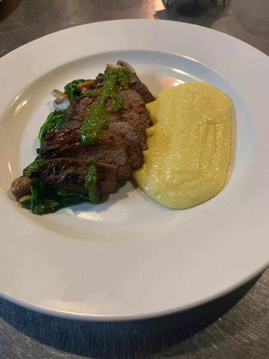 Steak night 7 oz top-sirloin with creamy polenta, mushrooms and chimichurri at NOLA Eatery & Bar, Queen Street East